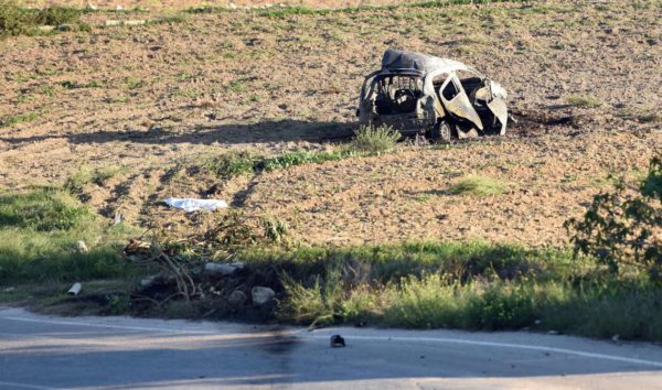 The wreckage of the car of investigative journalist Daphne Caruana Galizia lies next to a road in the town of Mosta, Malta, Monday, Oct. 16, 2017. Malta's Prime Minister Joseph Muscat said the bomb that killed reporter Daphne Caruana Galizia exploded Monday afternoon as she left her home in a town outside Malta's capital, Valetta. Rene Rossignaud/AP
