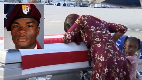 Sgt Johnson's widow with his coffin at Miami International Airport