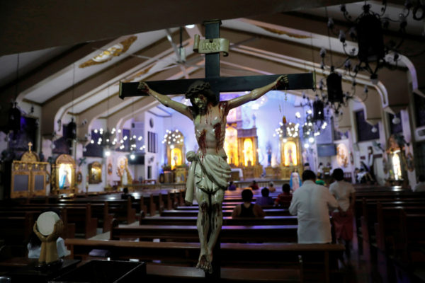 Members of the congregation pray during a Sept. 22 Mass at a Catholic church in Quezon City, Philippines. The Philippine House of Representatives has not renewed the license of the Catholic Bishops' Conference of the Philippines to operate dozens of radio stations across the country. (CNS/Dondi Tawatao, Reuters)