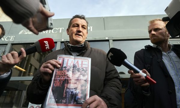 Fikret Alić holds a copy of Time magazine that featured his emaciated image on its cover in 1992. Photograph: Phil Nijhuis/AP