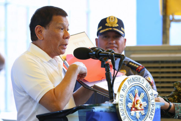 DRUG WAR. President Rodrigo Duterte shows a list of those allegedly involved in the illegal trade during his visit to the Ozamiz City Police Station on August 17, 2017. Also in the photo is Philippine National Police chief Ronald dela Rosa. Malacañang file photo
