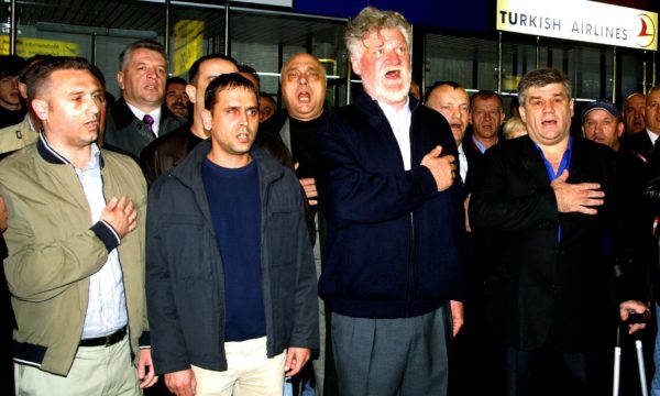 Slobodan Praljak, second from right, sings a Croatian hymn with former soldiers before his departure to the Hague tribunal in April 2004. Photograph: Antonio Bat/EPA