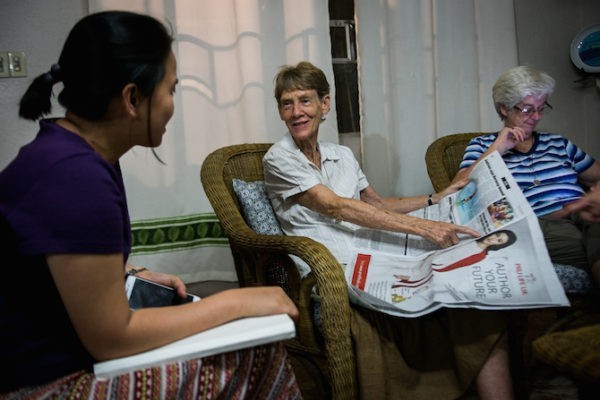 Sister Patricia Fox, provincial superior of the Our Lady of Sion Sisters, reads the news about her in her residence in Quezon City with other Sion sisters.