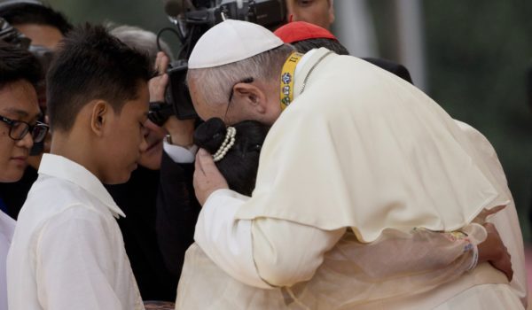 Pope Francis hugs two former street children during his meeting with youths in Santo Tomas University in Manila, Philippines. Photo: AP